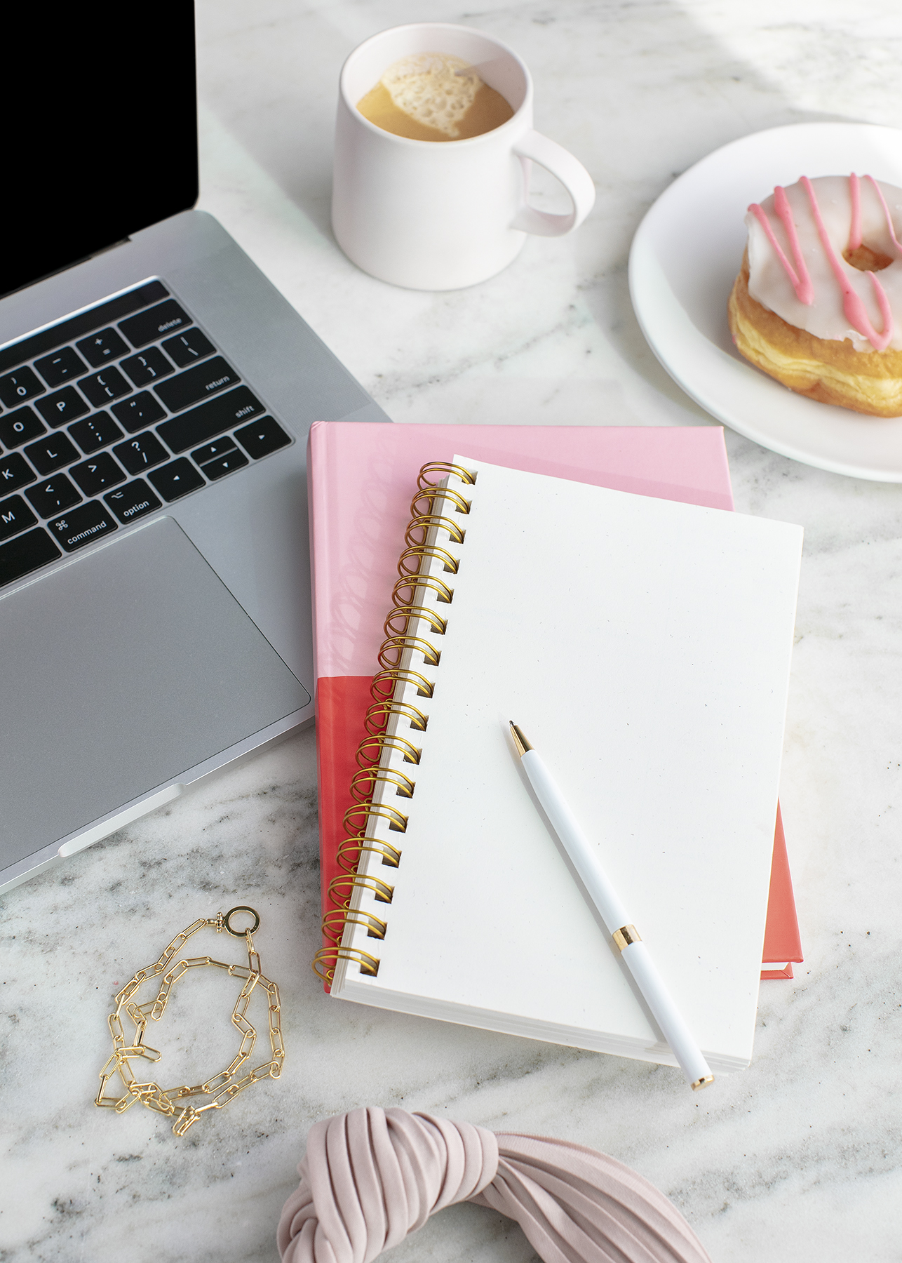 desk space with computer and notebooks showing working on numbers with confidence in your profit first system