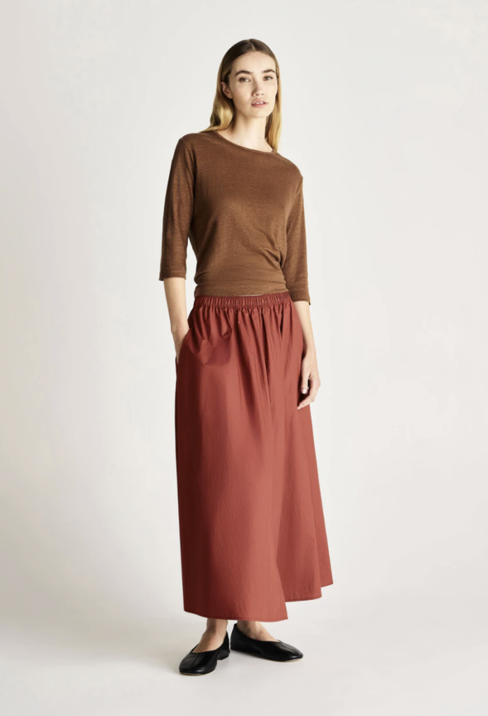 woman wearing cinnamon coloured skirt with elastic waist and pockets